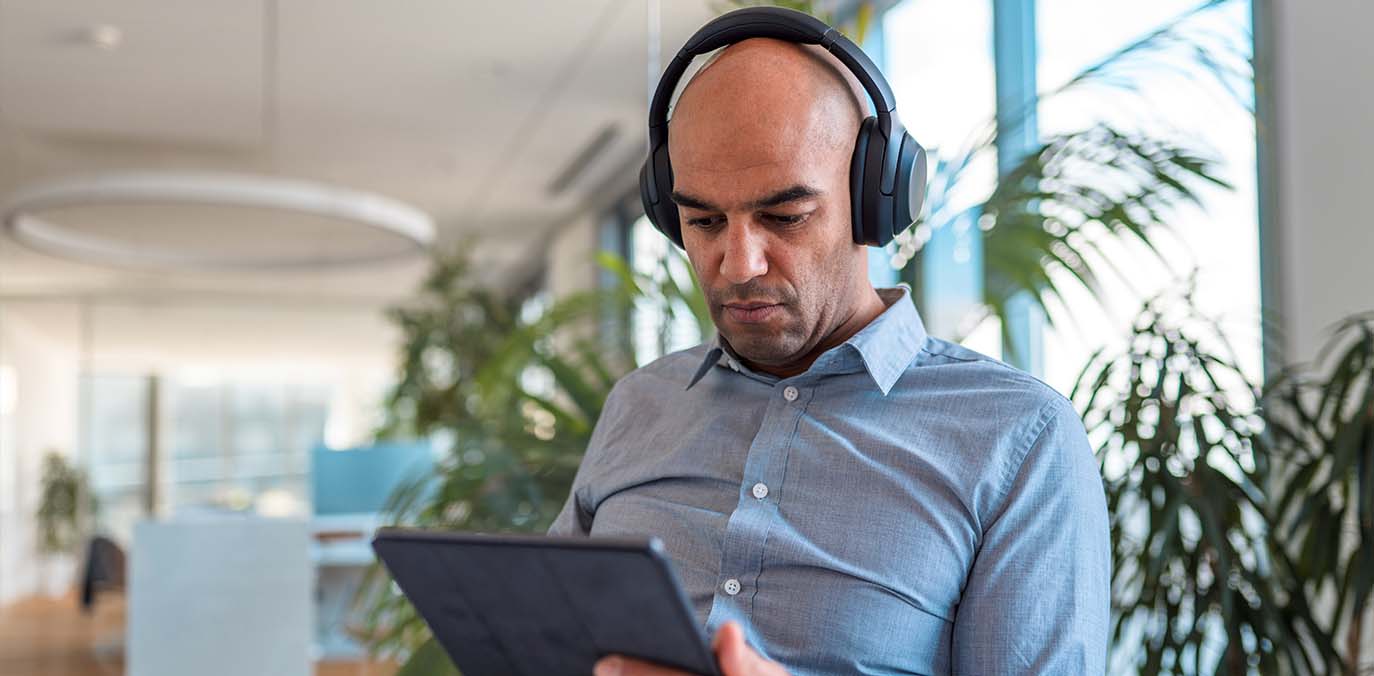 man-in-headphones-watching-ipad