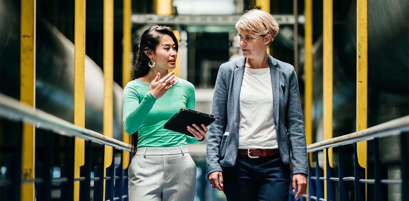 two-women-walking-and-talking-people